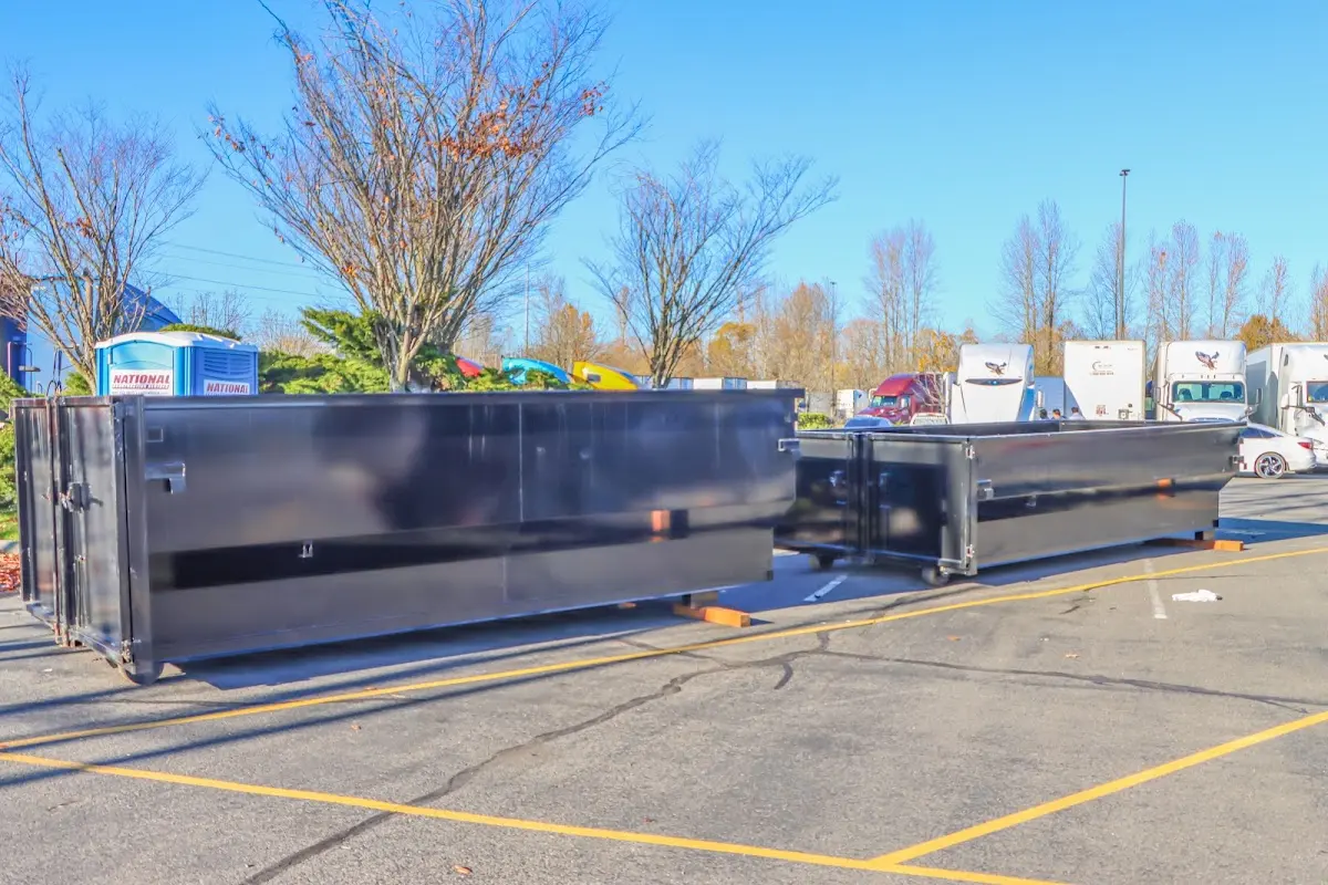 Professional dumpster rental service with roll-off container on residential driveway in Grass Valley